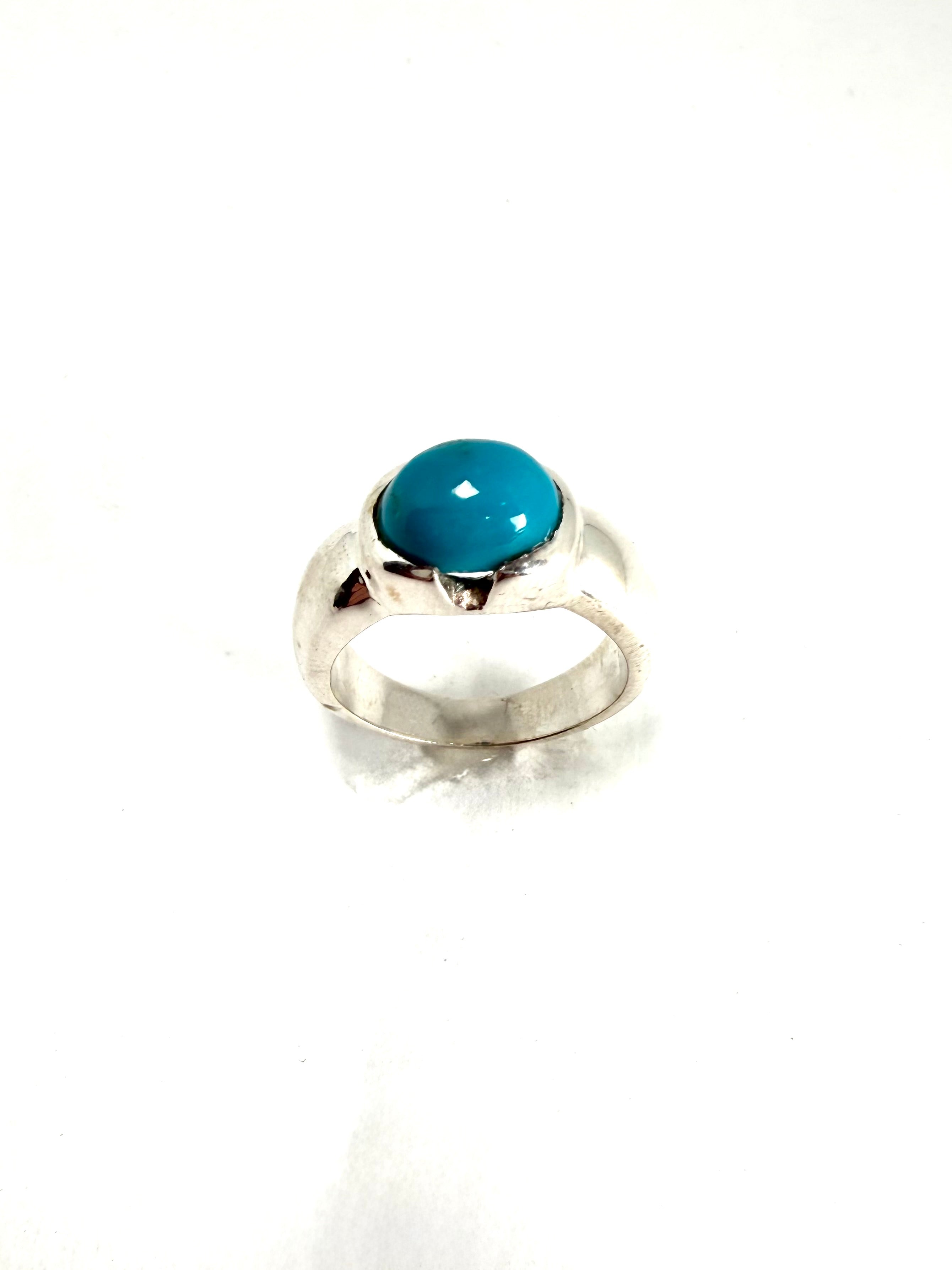 Silver ring with blue gemstone