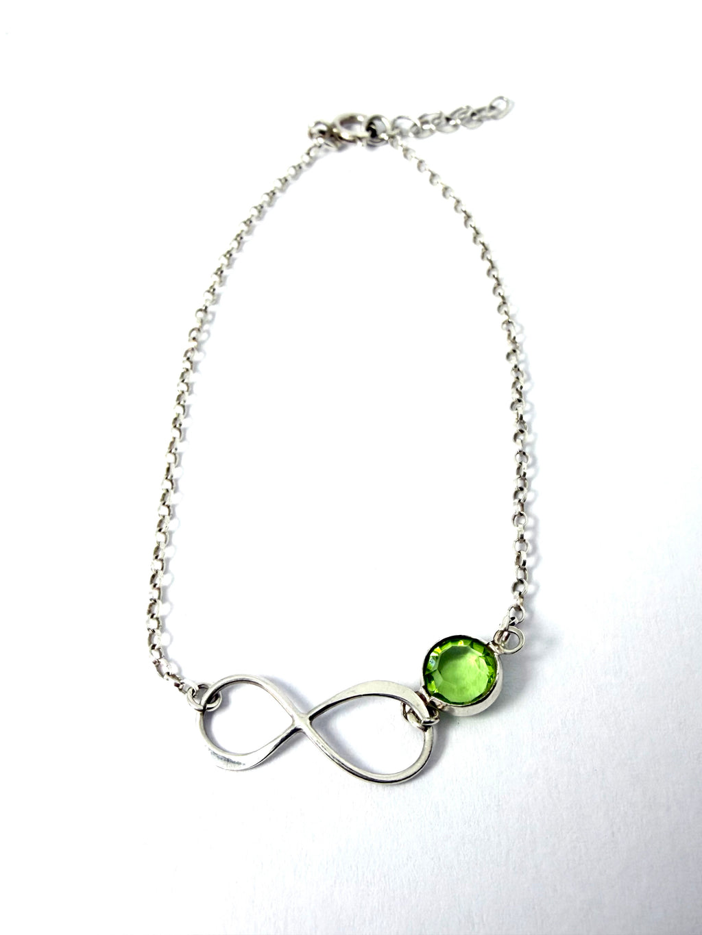 Silver infinity bracelet with green gemstone