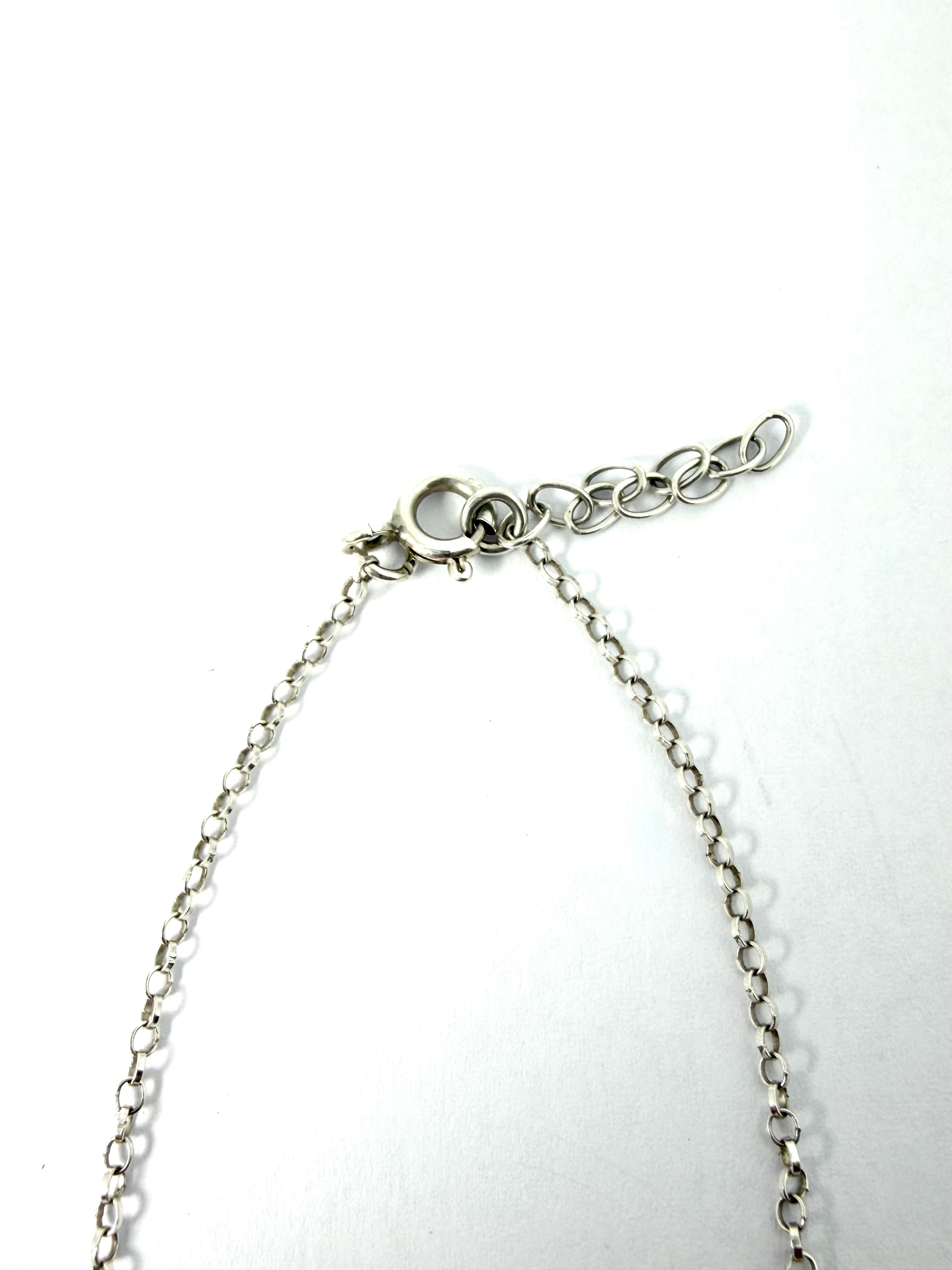 Silver infinity bracelet with green gemstone